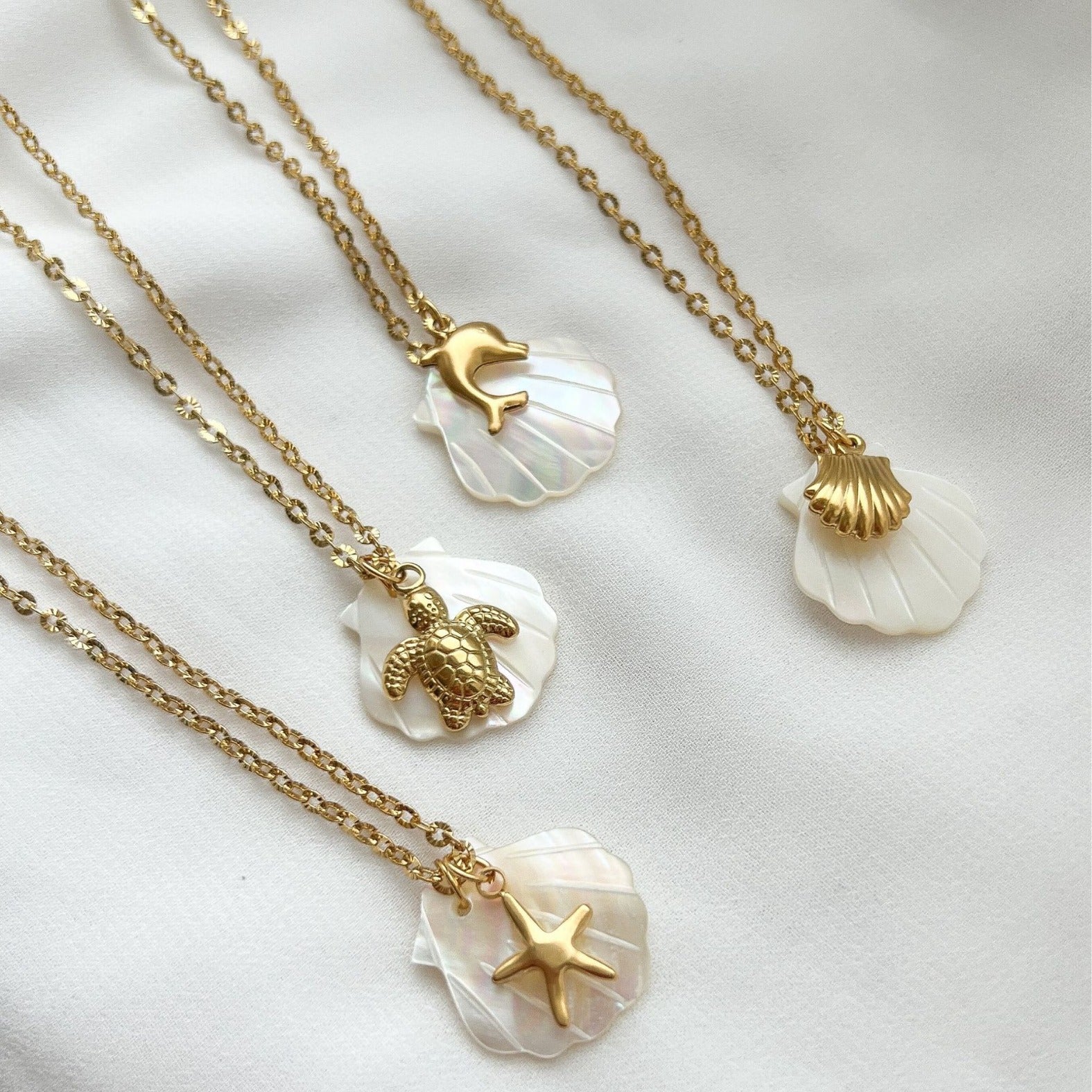 Collar con colgante de acero de titanio chapado en oro de 18 quilates con diseño de estrella de mar, delfín y concha de playa, estilo marinero, venta al por mayor