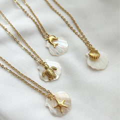 Collar con colgante de acero de titanio chapado en oro de 18 quilates con diseño de estrella de mar, delfín y concha de playa, estilo marinero, venta al por mayor
