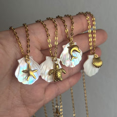 Collar con colgante de acero de titanio chapado en oro de 18 quilates con diseño de estrella de mar, delfín y concha de playa, estilo marinero, venta al por mayor