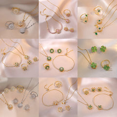 Joyería al por mayor: Anillos, pendientes y collar con incrustaciones de circonitas de acero y titanio con diseño de conejo, flor y copo de nieve.