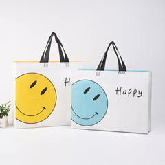 Bolsa de ropa no tejida prensada en caliente, disponible en stock, bolsa con expresión facial sonriente, bolsa de ropa para niños con impresión a color, bolsa de publicidad, impresión LO (por 50 piezas)